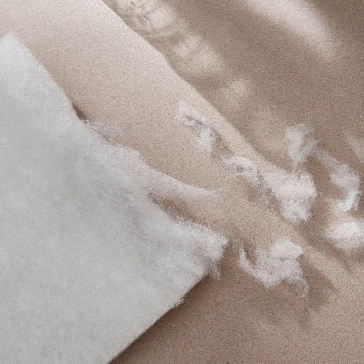 a piece of white fabric with a piece of white paper on top